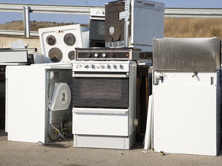 Old appliances stacked for removal
