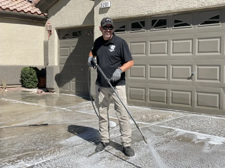 Technician power washing a driveway